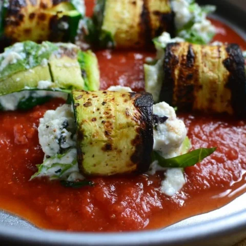 this is a plate of zucchini lasagna roll ups