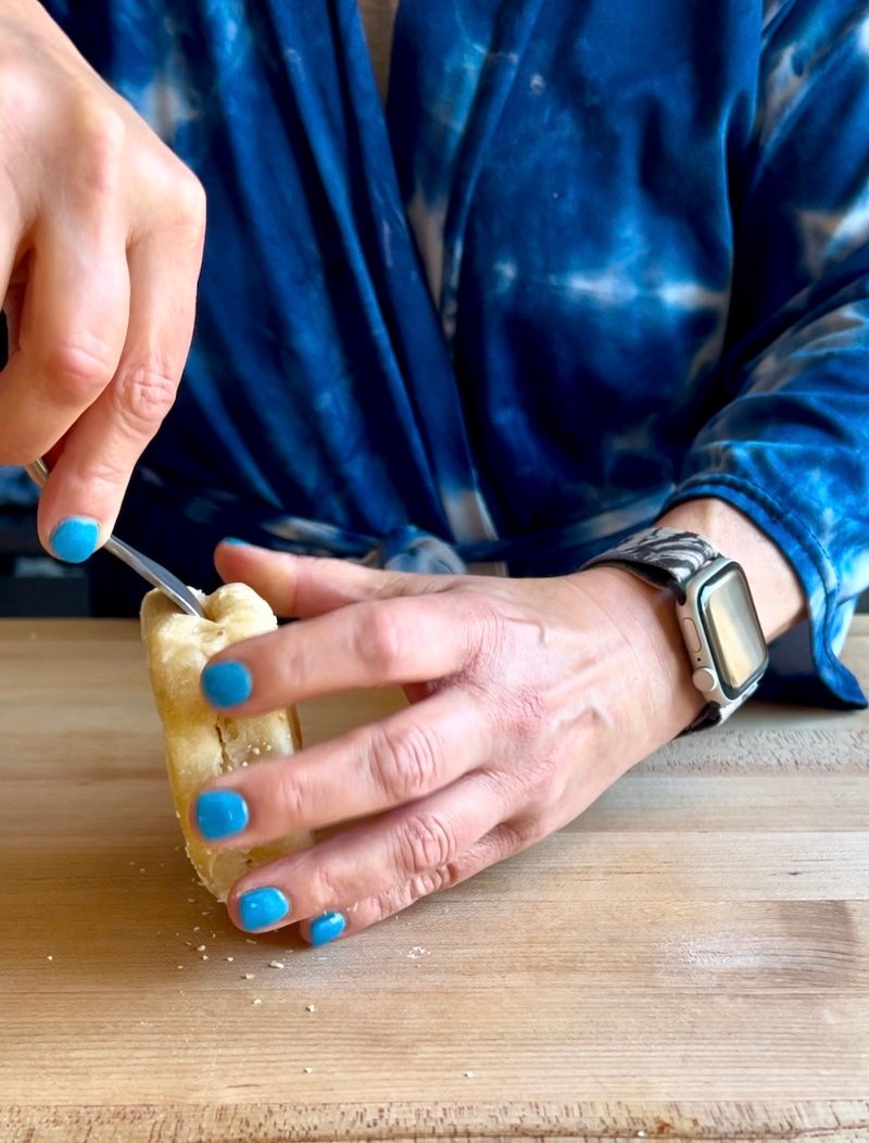 using a fork, separate the english muffin for toasting