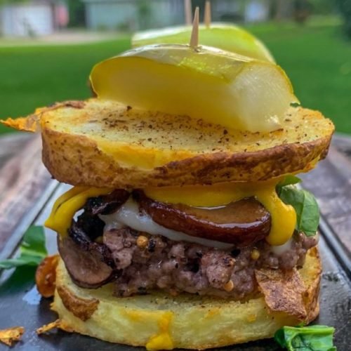 this is a photo of a burger between two slices of baked potato