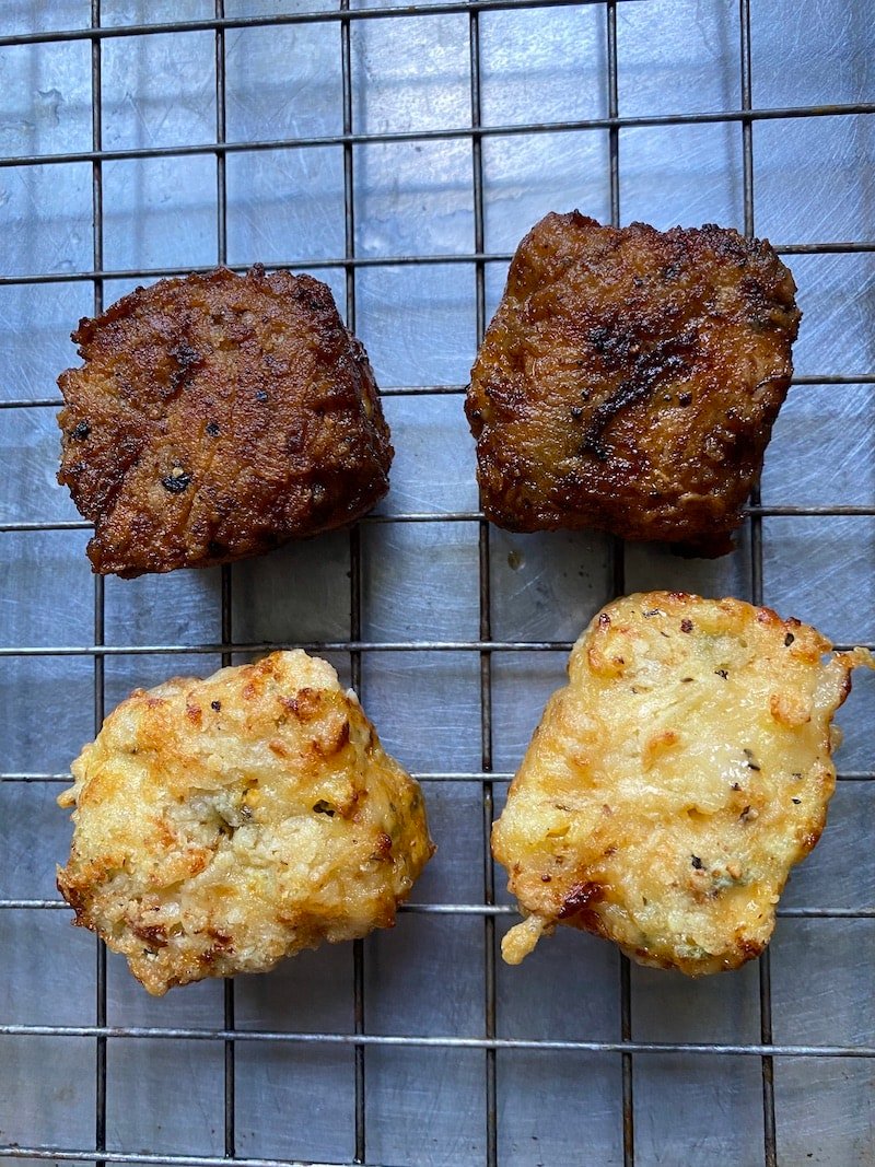 On a cookie rack, it shows the chicken nuggets cooked two ways - one pan fried and one in the air fryer. The pan fried version is darker and crispier than the air fried version.
