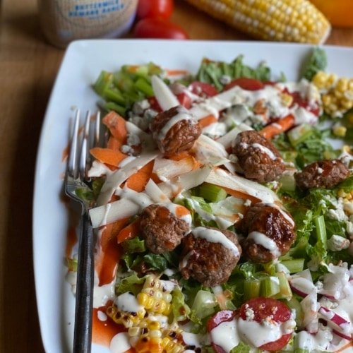 this is a photo of a salad with cheeseburger croutons