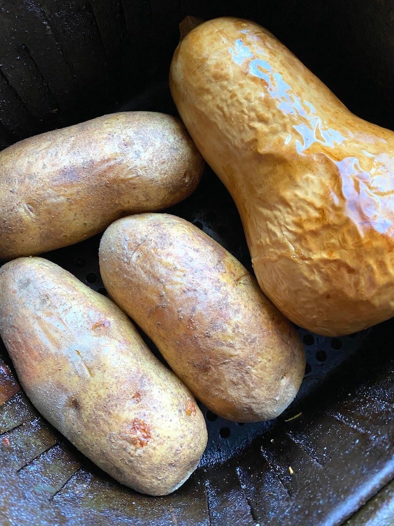 this is a photo of baked potatoes and a butternut squash roasted in an air fryer
