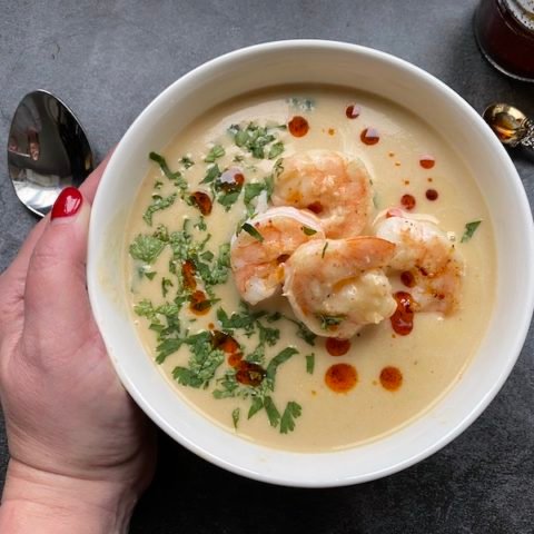 this is a photo of acorn squash bisque with grilled shrimp