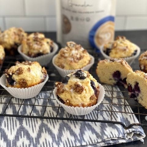 blueberry muffins on a rack with a granola topping