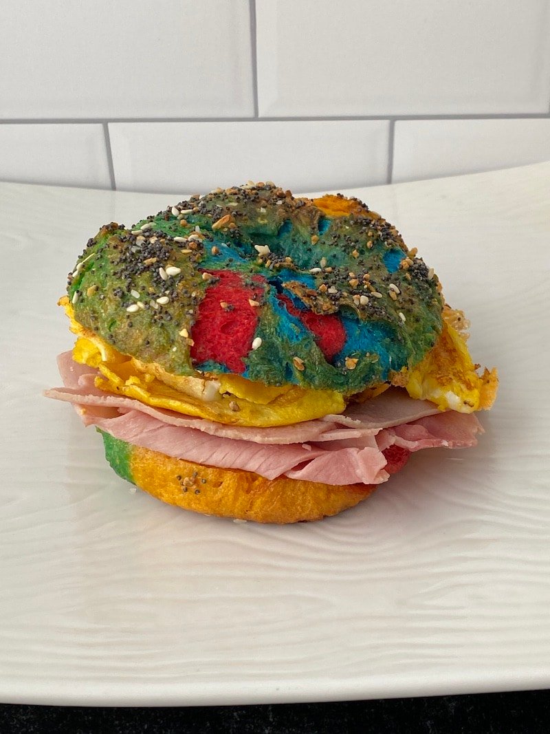 this is a photo of a rainbow bagel sandwich