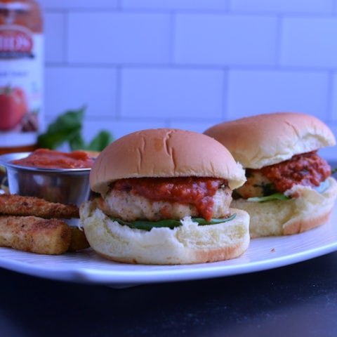this is a photo of two turkey parmesan sliders with zucchini fries