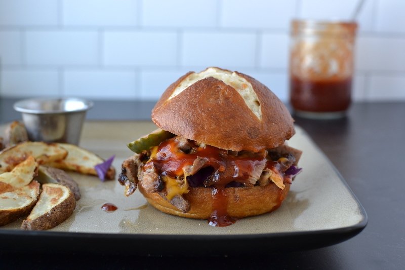 pork bbq sandwich with fries on a plate