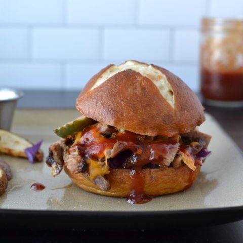 bbq pork sandwich on a plate with fries