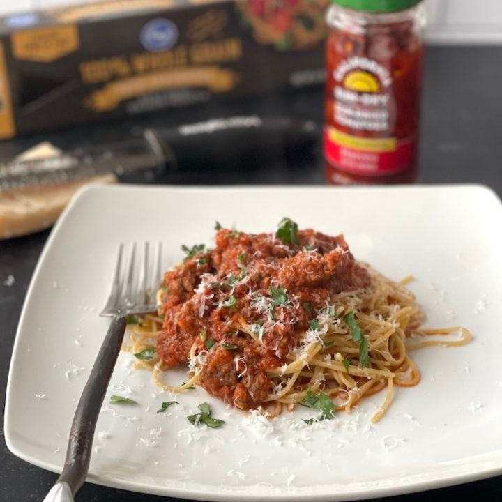 this is a photo of beef bolognese over whole grain pasta