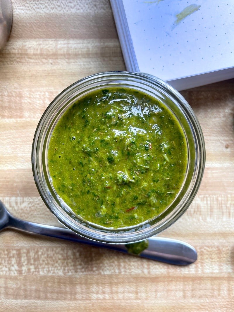 this is a photo of spinach chimichurri sauce in a jar