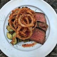 this is a photo of pan seared chuck roast with onion rings