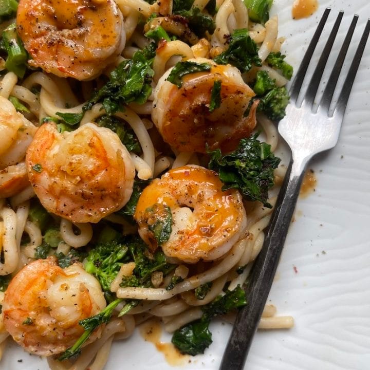 this is a photo of shrimp lo mein with broccoli rabe