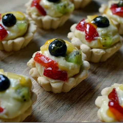 this is a photo of mini fruit tarts with apricot glaze