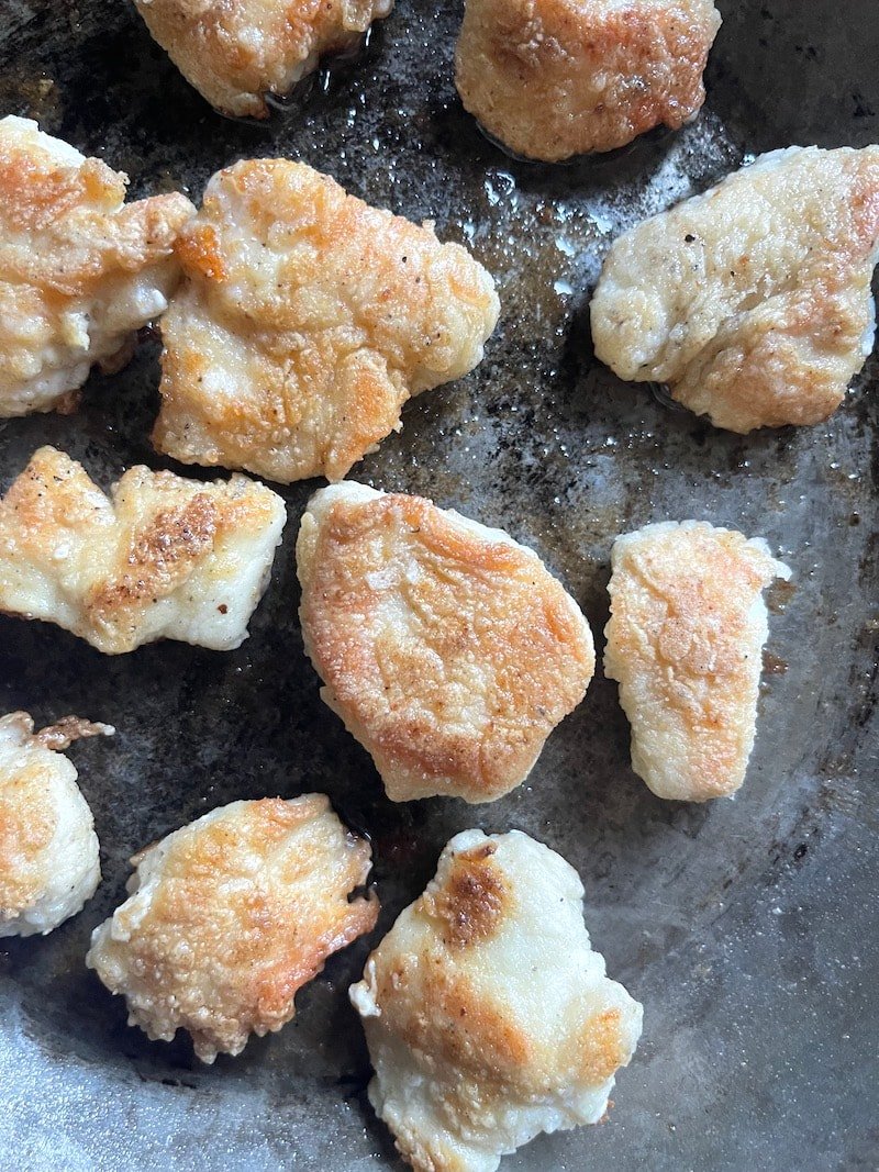 This is a photo of chicken nuggets cooked in a skillet with avocado oil spray