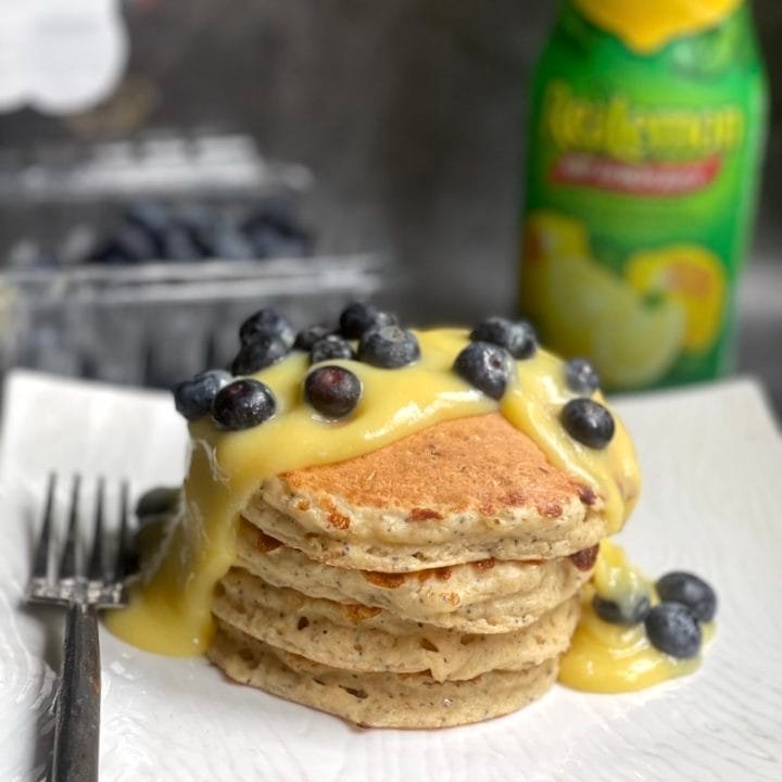 this is a photo of poppy seed pancakes with lemon curd and fresh blueberries