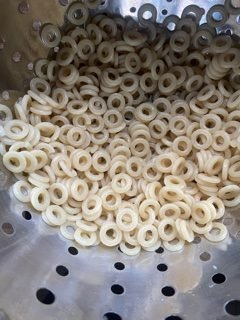 this is a photo of circle shaped pasta that is cooked to make homemade spaghettios