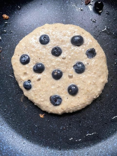 this is a photo of banana oat pancakes with blueberries