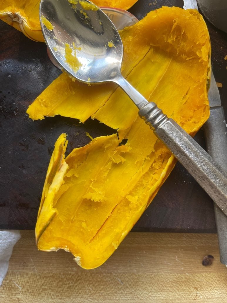 this is a photo of a delicata squash with the pulp scooped out 
