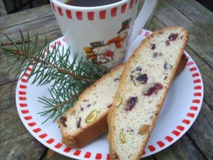 this is a photo of biscotti on a snowman plate with a cup of coffee