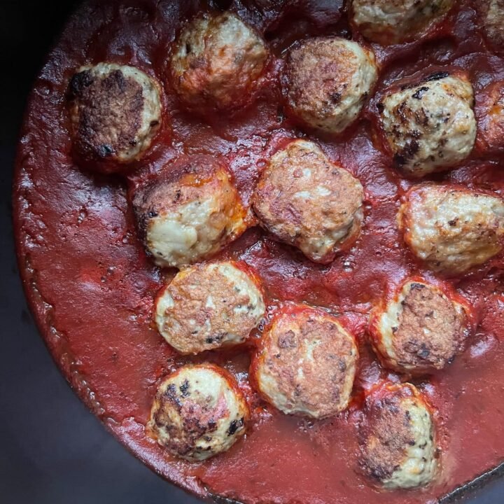 this is a pot of turkey meatballs in marinara sauce