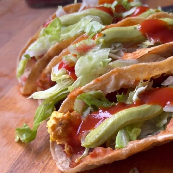 a plate of three bean and egg tacos