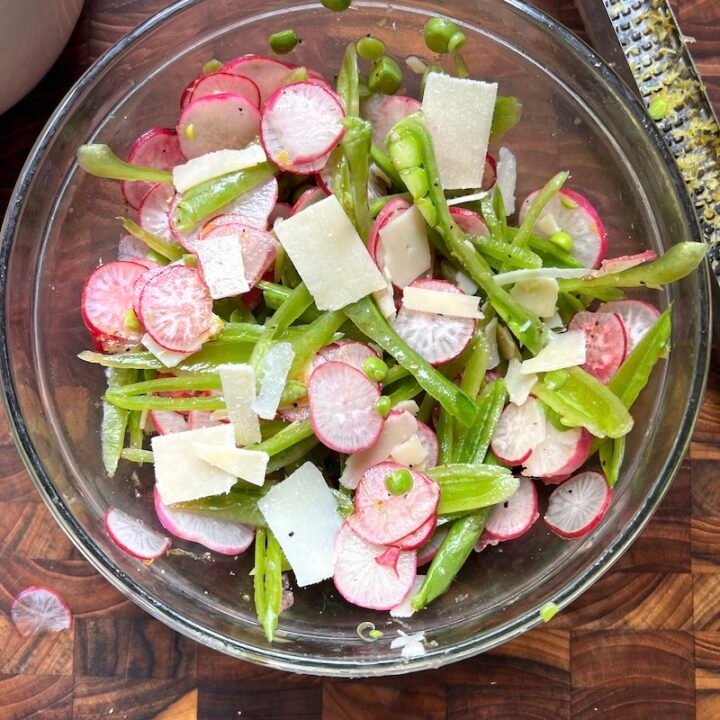 Sugar snap pea and radish salad in a bowl.