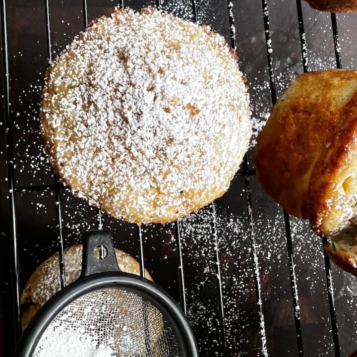 This is a photo of a zucchini muffin with powdered sugar