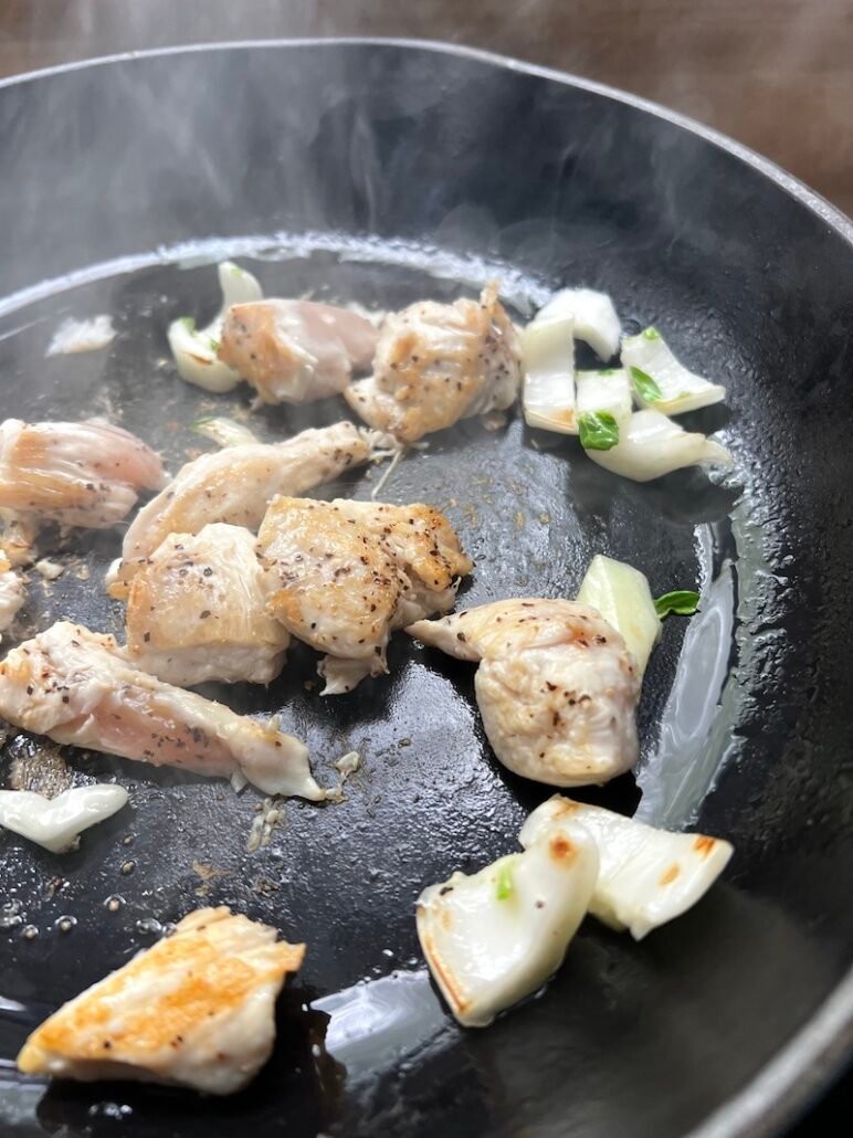 chicken and bok choy in a pan
