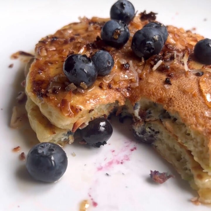 this is a plate of coconut blueberry pancakes