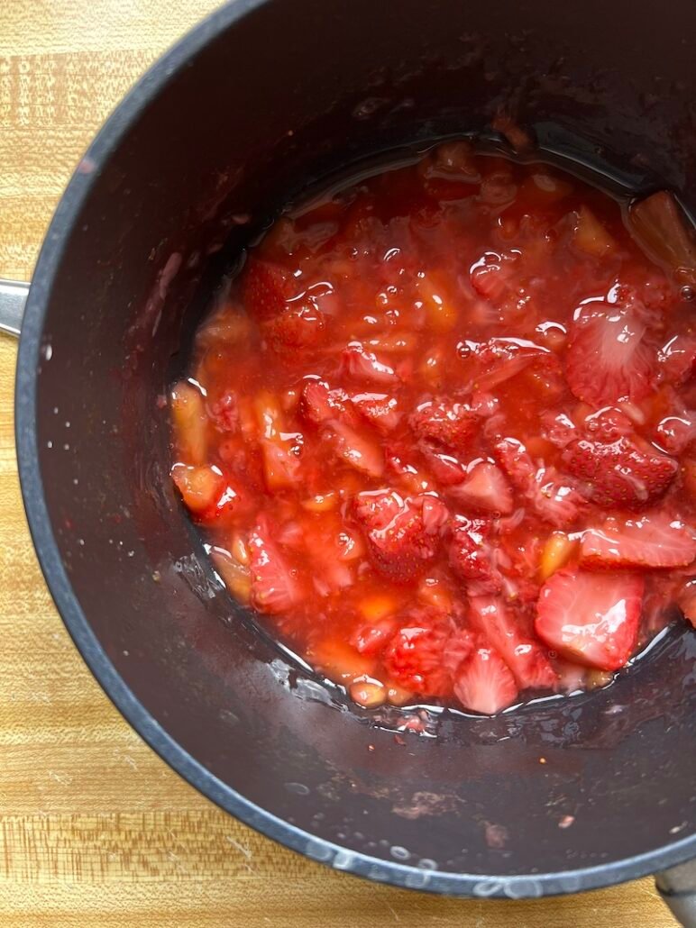 this is a pot of very berry sauce - a combination of strawberries and pineapple cooked down into a sauce