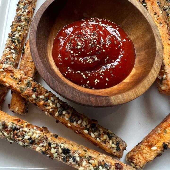 this is a photo of crispy sweet potato fries with ketchup for dipping