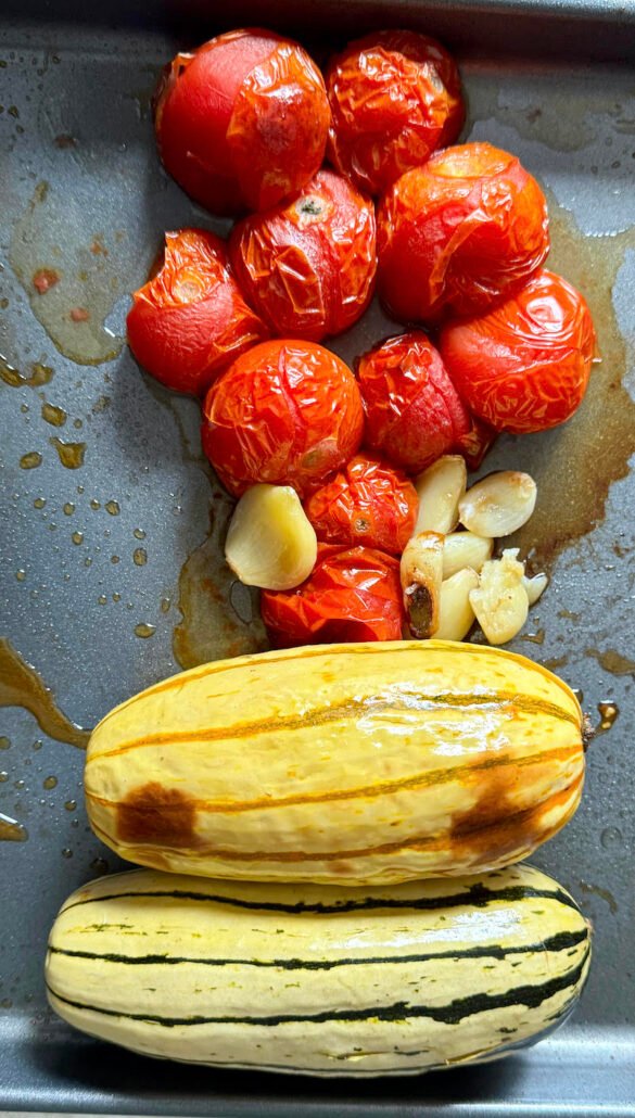 this is a sheet tray of roasted delicata squash and tomatoes to make sauce