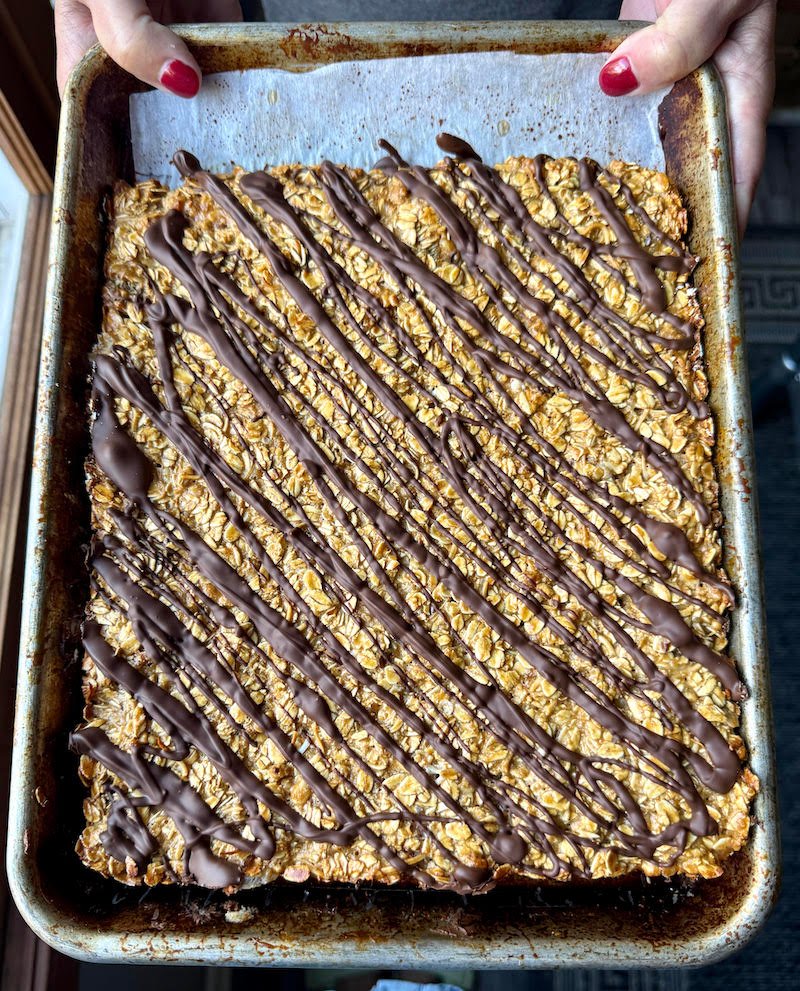 this is granola cooled out of the oven drizzled with chocolate