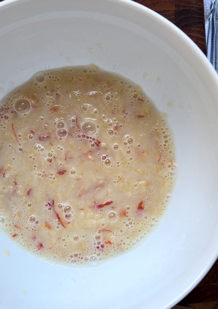 this is a bowl of wet ingredients to make apple donuts