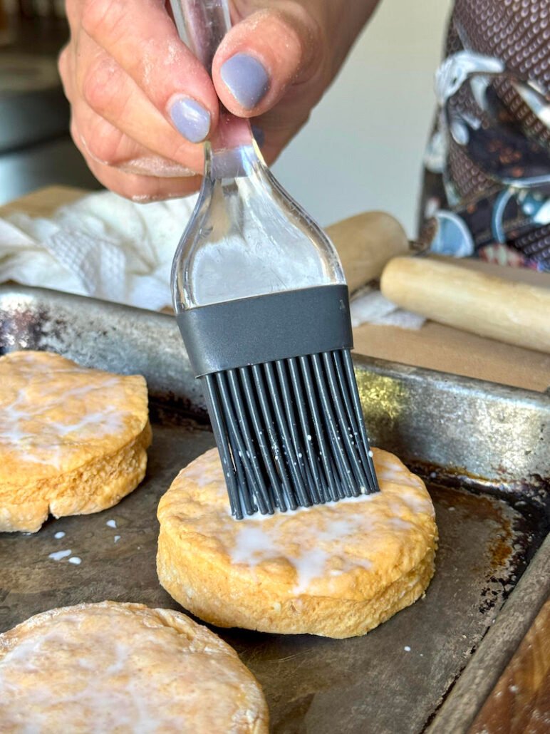 brushing milk on biscuits before baking