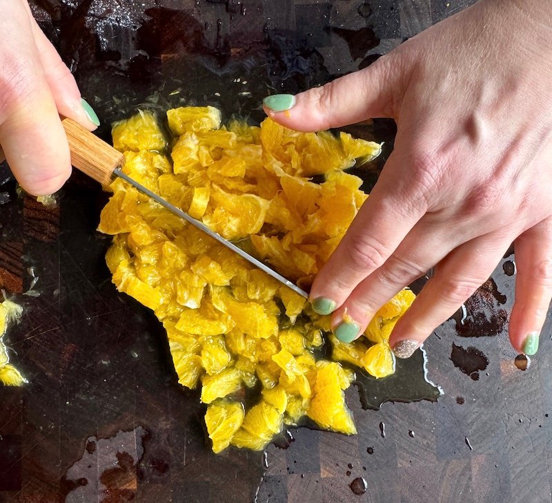 chopping oranges for creamsicle cupcakes