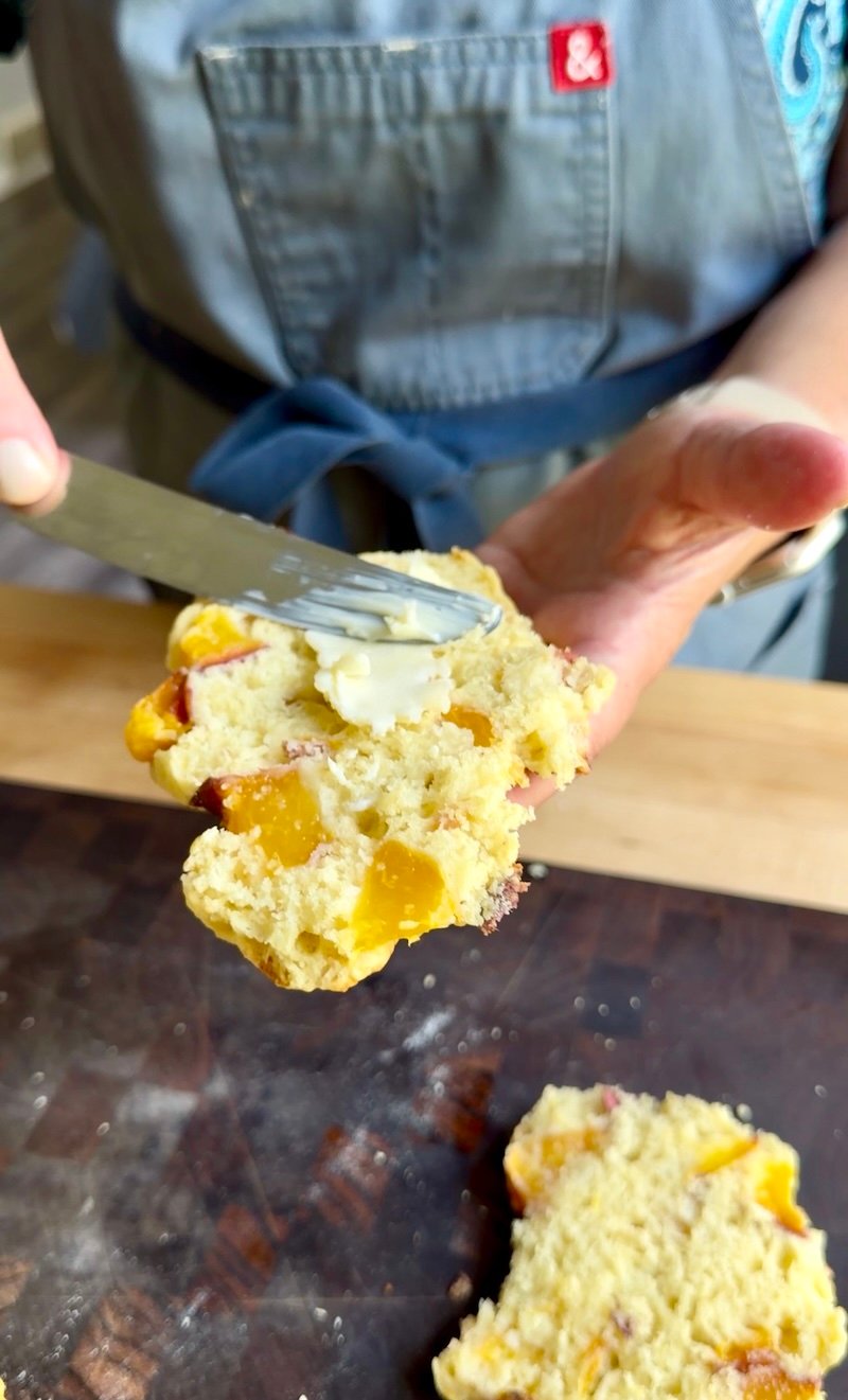 adding butter to biscuit