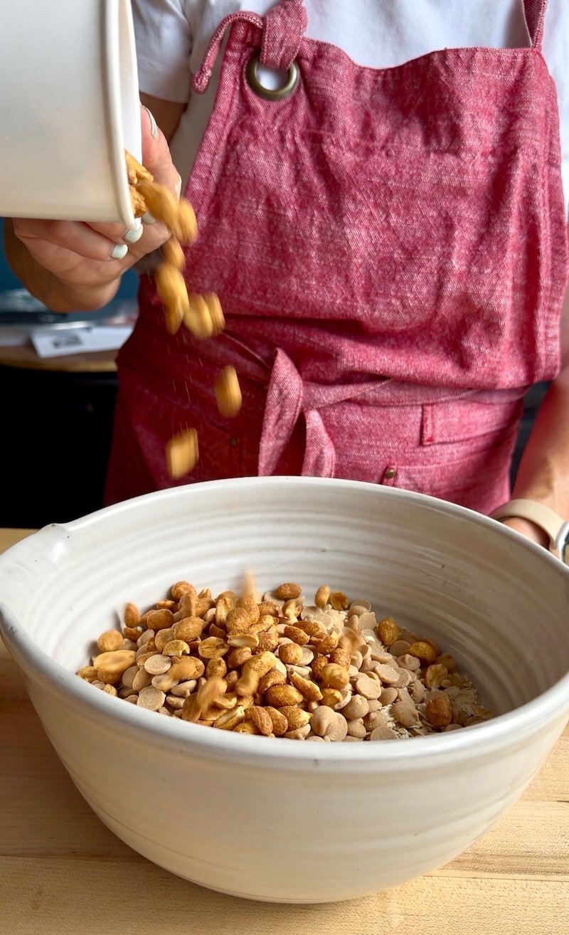 nuts being added to nutter butter granola