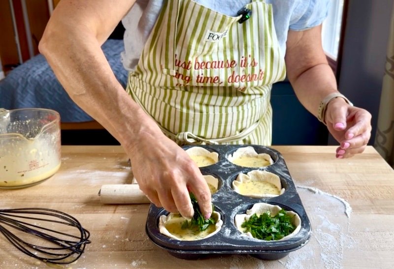 a cook making quiche muffins