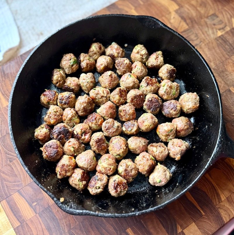 mini meatballs in a cast iron skillet