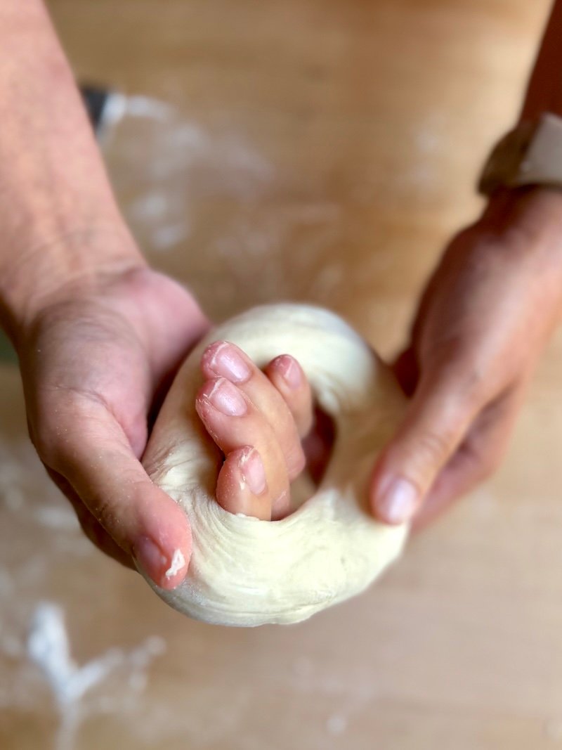 putting a hole into bagel dough to shape and bake