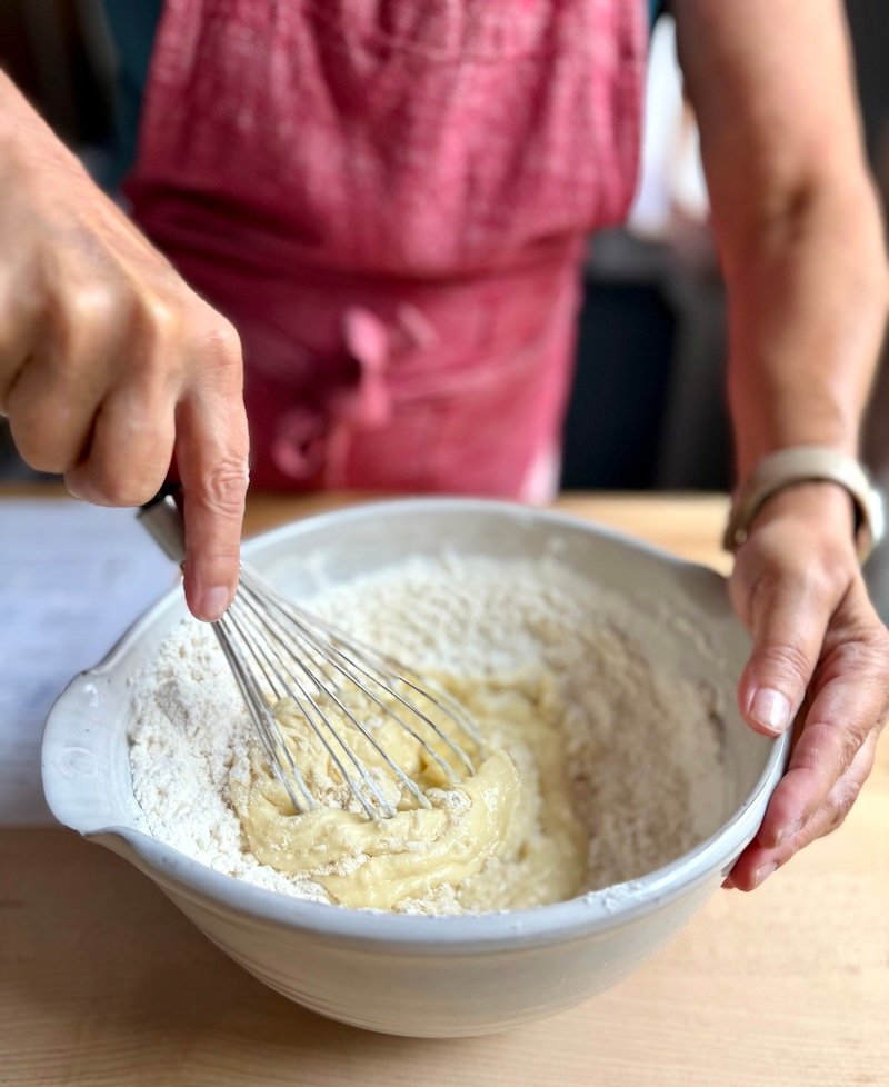 adding dry ingredients to wet ingredients