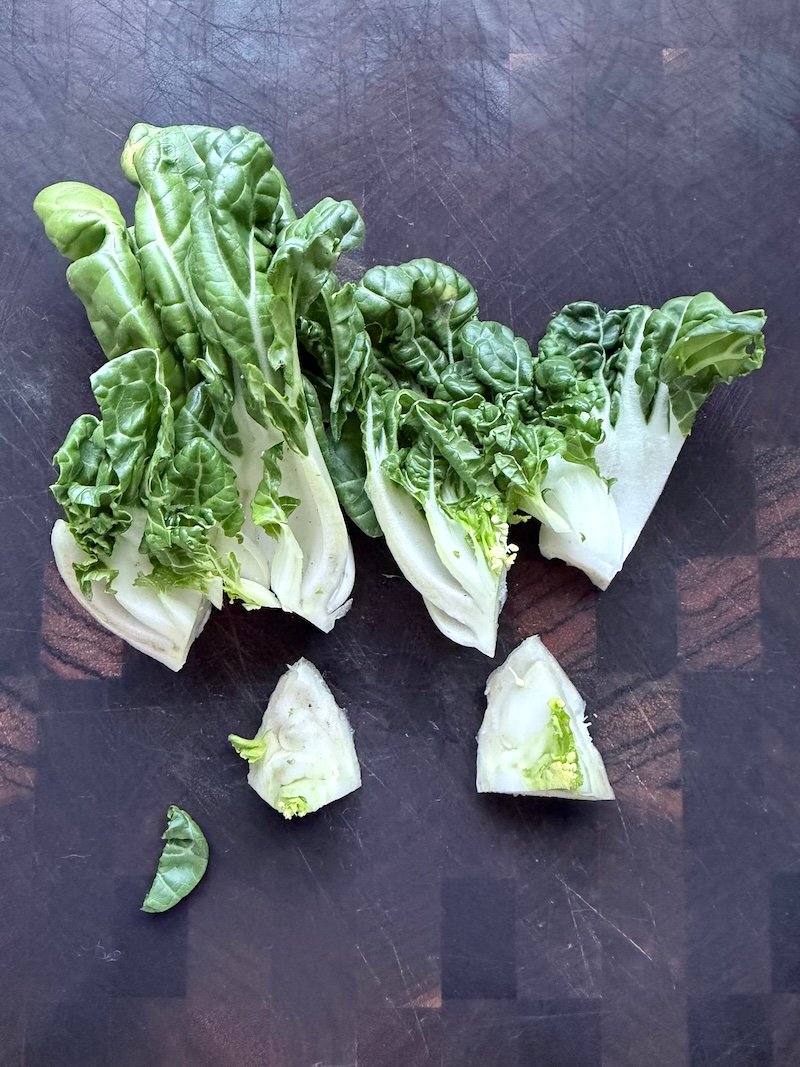 cutting out the core of a baby bok choy